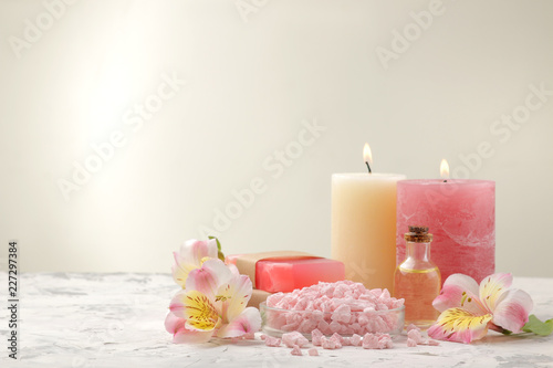 Spa composition with sea salt  aroma oils and handmade soap with flowers. spa concept. on a light background. with space for inscription