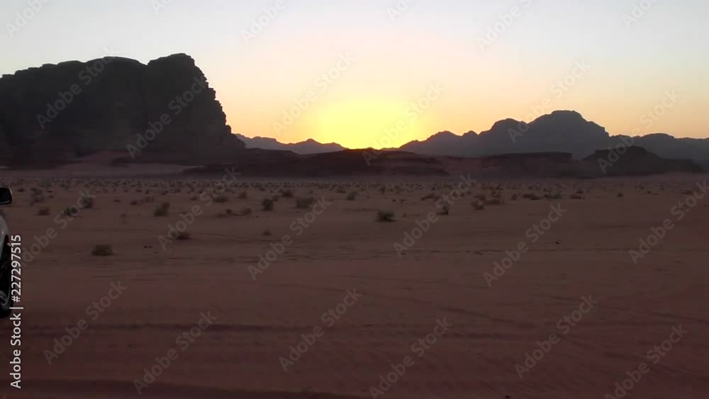 Sunset over the Wadi Rum desert in the Hashemite Kingdom of Jordan, also known as The Valley of Moon Sunset over the Wadi Rum desert in the Hashemite Kingdom of Jordan, also known as The Valley of Moon