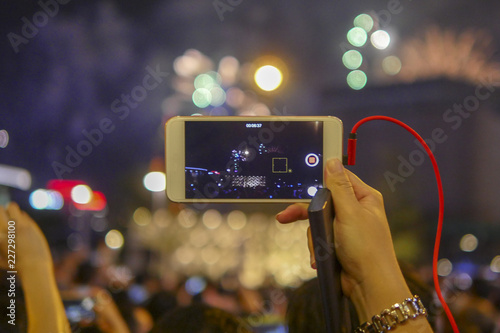 Holiday, colorful sky, fireworks shoots on smartphone
