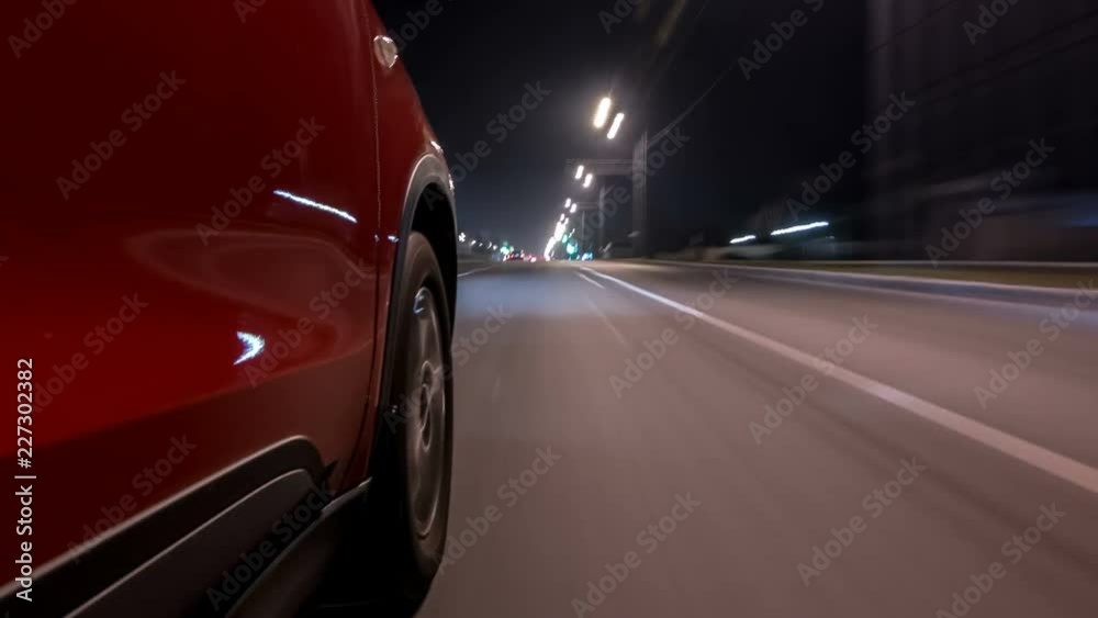 Drivelapse urban look from fast driving car at a night avenue in a city timelapse hyperlapse