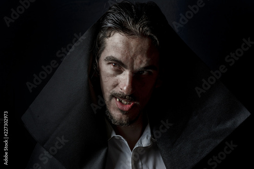 Scary Vampire in the hood with Red eyes full of blood