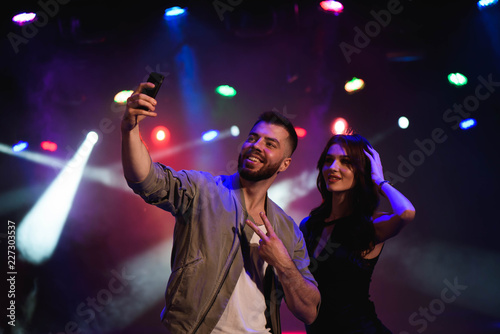 Couple take a selfie with a mobile in the night celebration