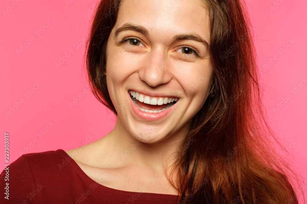 emotion face. very happy joyful thrilled to bits woman with beaming smile. young beautiful brown haired girl portrait on pink background. emotion face. very happy joyful thrilled to bits woman with beaming smile. young beautiful brown haired girl portrait on pink background.