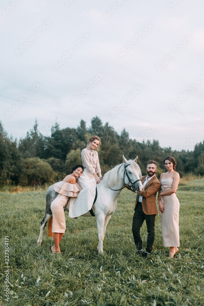 Wedding in American style, on a ranch with a horse. Walk couples in the fields at sunset, with friends and on horseback. Modern couple and ideas for the ceremony. Wedding in American style, on a ranch with a horse. Walk couples in the fields at sunset, with friends and on horseback. Modern couple and ideas for the ceremony.