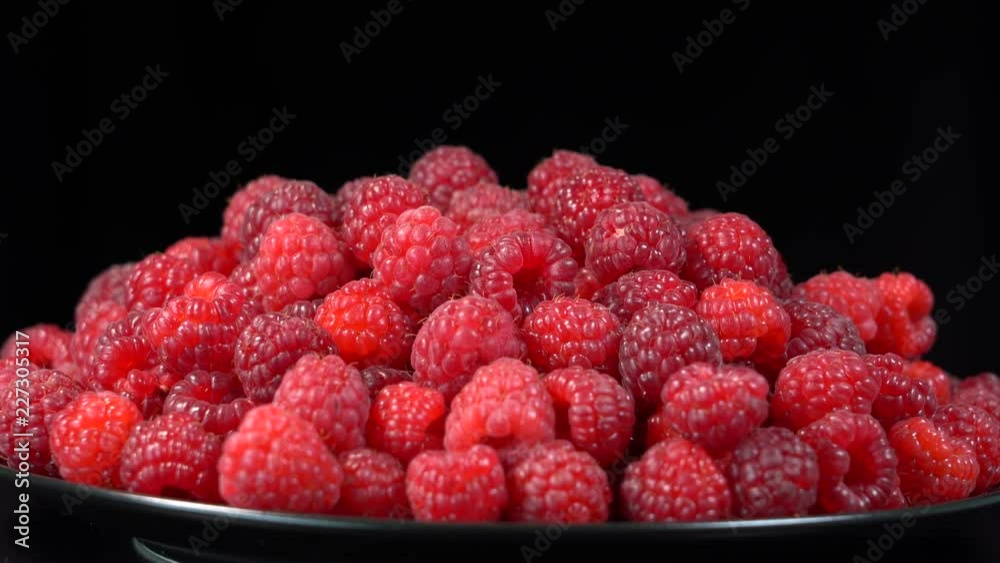 Fresh, ripe, juicy raspberry background, close up berry, rotation loopable 4k . Food background. Gastronomy concept, organic food. Macro red raspberries fruit in plate on black background Fresh, ripe, juicy raspberry background, close up berry, rotation loopable 4k . Food background. Gastronomy concept, organic food. Macro red raspberries fruit in plate on black background