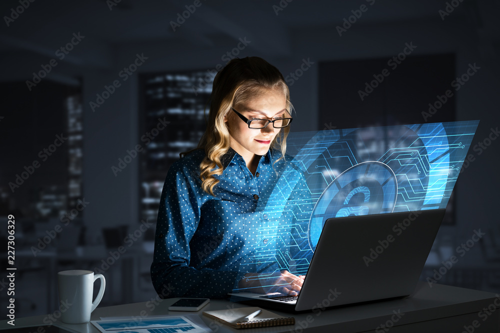 Beautiful blonde in dark office working on laptop and getting net access Beautiful blonde in dark office working on laptop and getting net access