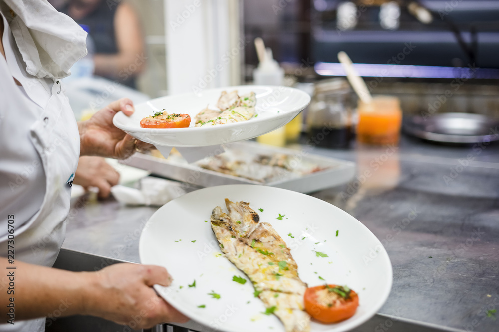 White fish fillet carried by cook in the restaurant White fish fillet carried by cook in the restaurant