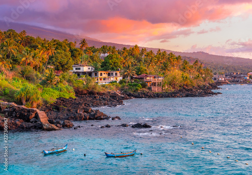 Sunset boats in holiday paradise resort on Grand Comore island, Comoros. Beautiful sunset light of sun in the sea. Villas on the beach with private beach. Moroni Comoros, Itsandra beach resort hotel photo