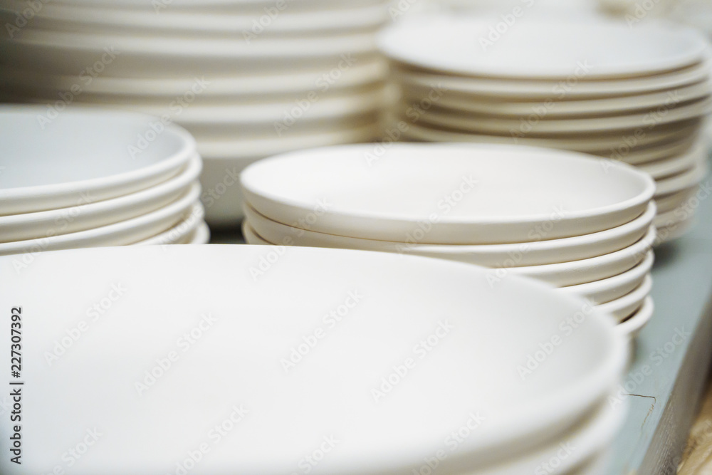 Many white different plates stacked together Many white different plates stacked together