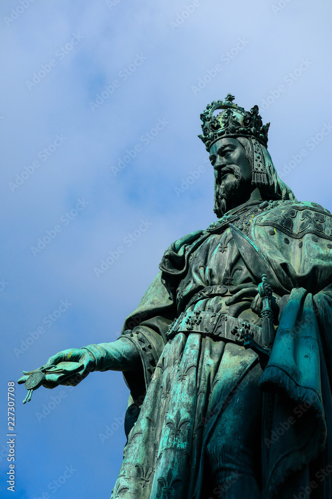 Fototapeta premium Statue of King Charles, Prague, on a blue sky background. Monument sculpture of the Czech King Charles 4
