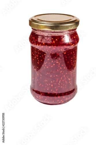 Raspberry jam in glass jar isolated on white background