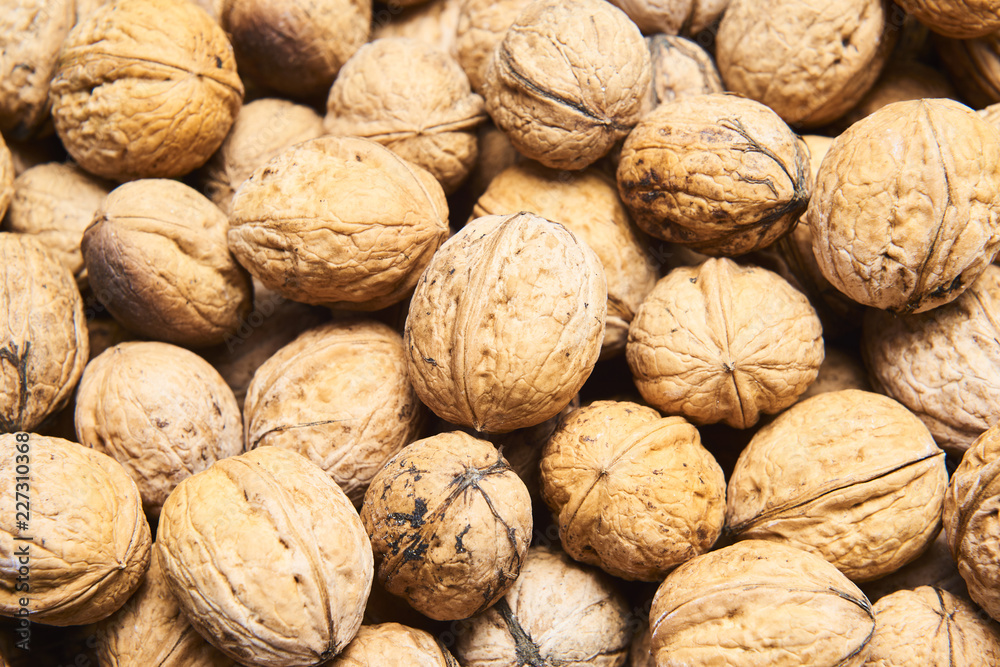 Walnut background, scattered pile of walnuts Walnut background, scattered pile of walnuts