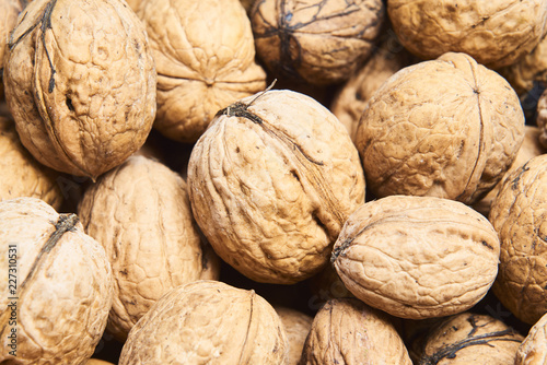 Walnut background, scattered pile of walnuts