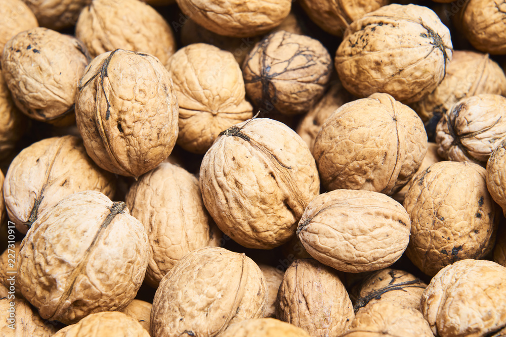 Walnut background, scattered pile of walnuts Walnut background, scattered pile of walnuts