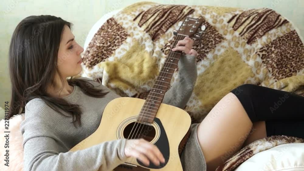 Girl lying in a chair with a guitar