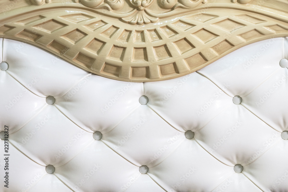 Obraz premium Close-up white fabric upholstered headboard with buttons textile background, retro Stylish bedroom furniture