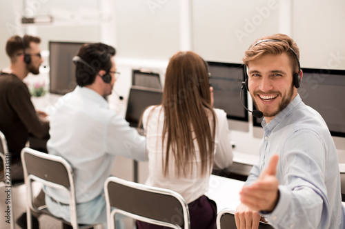 rear view. young customer service agent sitting at his Desk