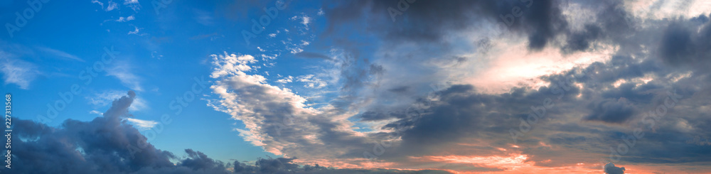 Beautiful panorama of the evening blue sky with colored clouds Beautiful panorama of the evening blue sky with colored clouds