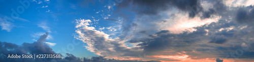 Beautiful panorama of the evening blue sky with colored clouds photo