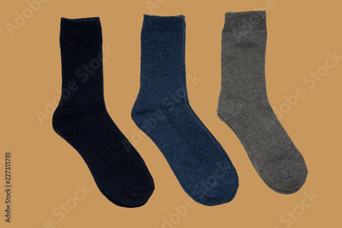 Three pairs of warm socks on brown background
