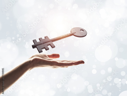 Key to new opportunities and success concept by symbol on hand.  photo