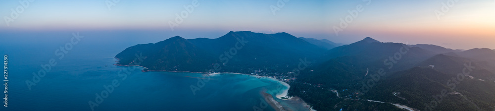Sunset ocean, island. Aerial drone shot. Panorama. Thailand. Wonderful overview scenery Ko Pha-ngan island and the ocean at the colorful sunset. The Kingdom of Thailand (former Siam), Southeast Asia.