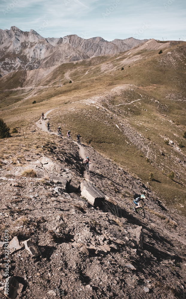 Mountain bikers climbing towards the summit in the Alps