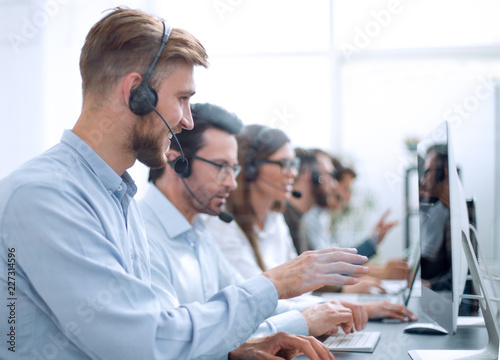 handsome man with a headset working in a call center