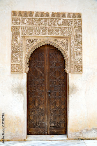 Medieval moorish-style door on a brick building in Granada, Spain