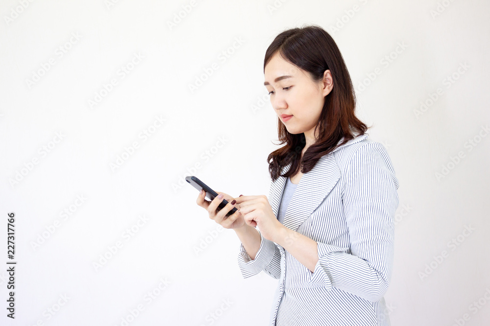 Portrait of beautiful Asian business girl using a smart phone close up on white background. Portrait of beautiful Asian business girl using a smart phone close up on white background.