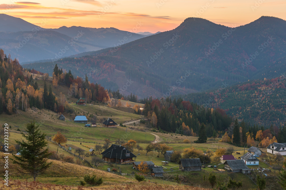 Colorful autumn landscape in the mountain village. Foggy morning in the Carpathian mountains, Ukraine