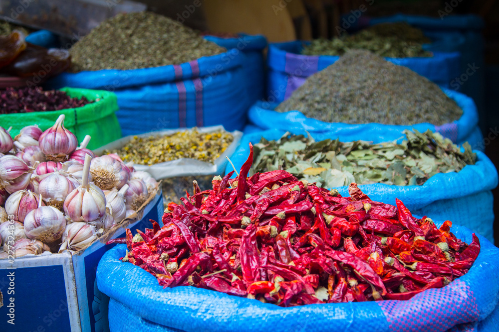Big bags of blue with dried chili peppers, garlic and other spices on the market in the medina of Marrakesh. Africa Morocco