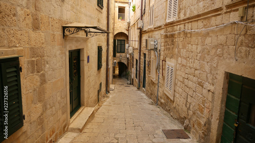 View of the historic city of Dubrovnik. View from the city walls to the medieval old town, buildings dating from the Middle Ages located by the sea. A frequent place of turistic tours.
