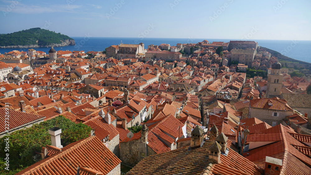 View of the historic city of Dubrovnik. View from the city walls to the medieval old town, buildings dating from the Middle Ages located by the sea. A frequent place of turistic tours.