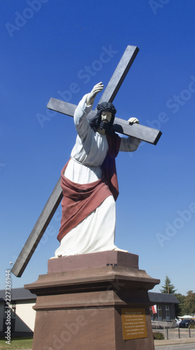 Christ statue with a cross in Wachock in Poland