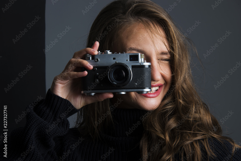 young woman holding old retro analog photo camera smiling banner concept young woman holding old retro analog photo camera smiling banner concept