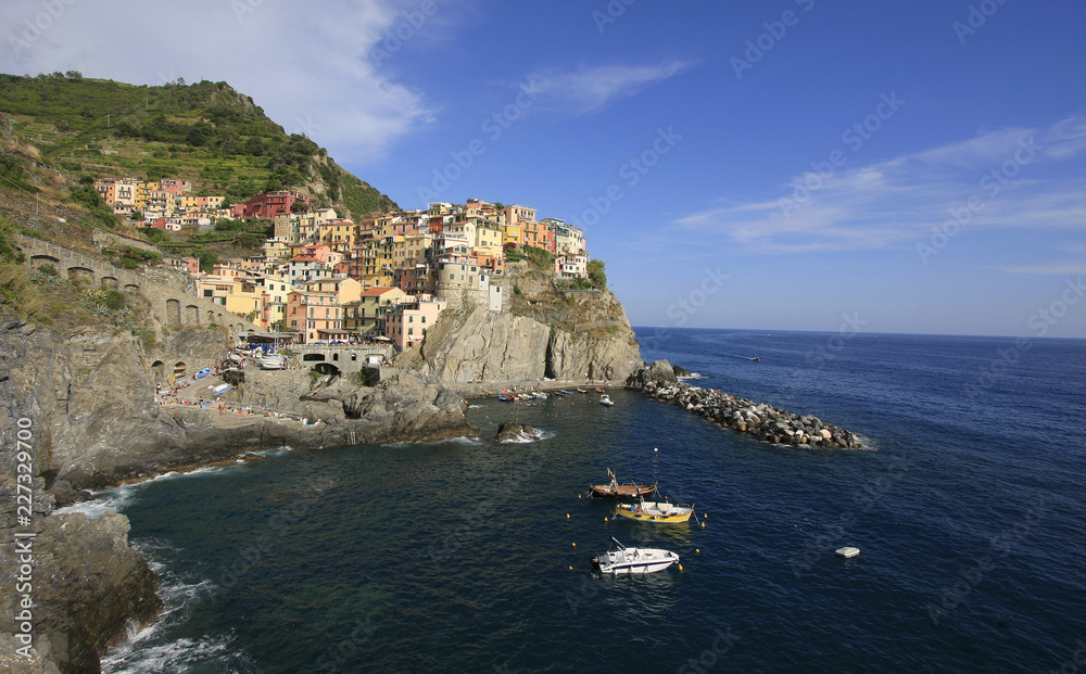 Colorful village of Manarola with fisher boats on the foreground, Cinque Terre, Italy