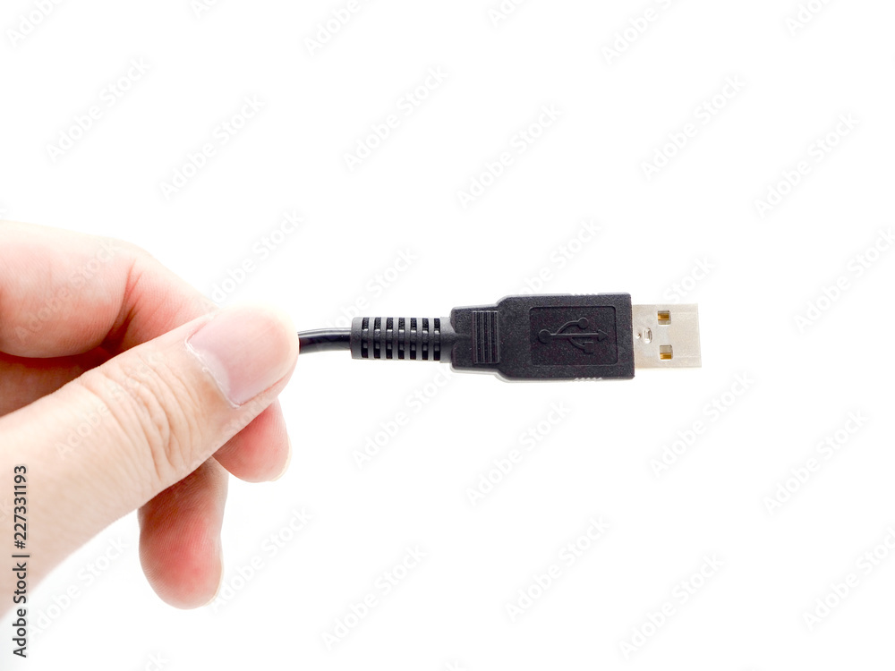 Hand holding USB cable isolated on a white background. Hand holding USB cable isolated on a white background.