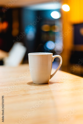 White coffee or tea mug on a wooden desk