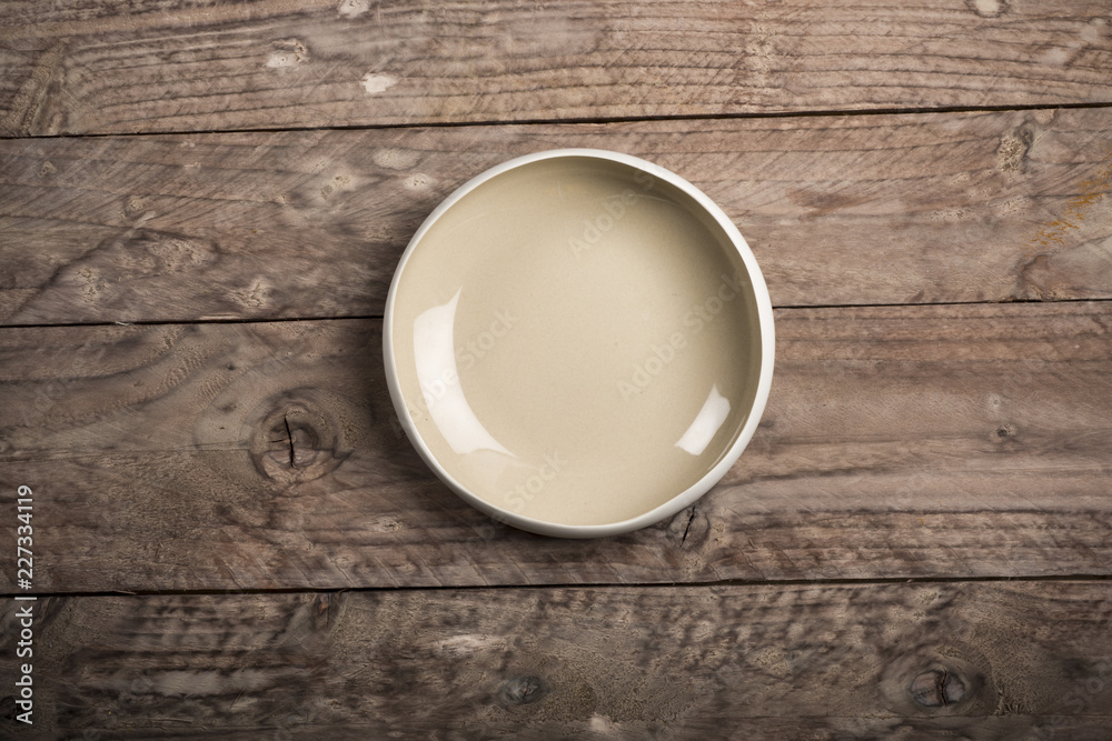 Empty dish on wood background. Top view. Empty dish on wood background. Top view.