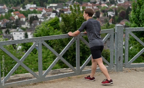 the guy warming up before training with a beautiful view of the city in Germany