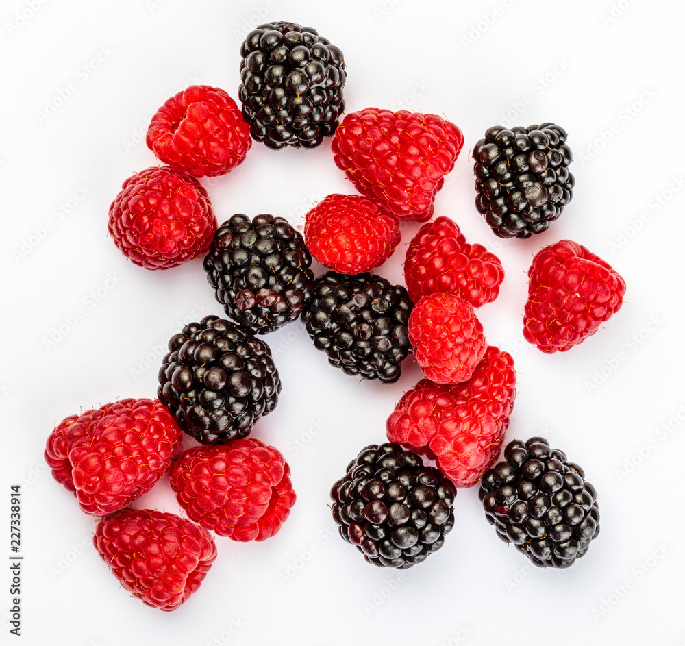 They look like artificial treats! But they are delicious and beautiful blackberries and fresh raspberries. Isolated on white background. They look like artificial treats! But they are delicious and beautiful blackberries and fresh raspberries. Isolated on white background.