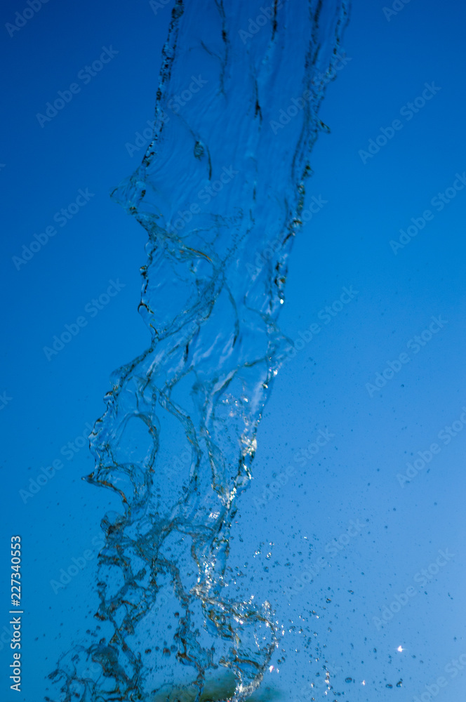 transparent falling water vertical flows, close up transparent falling water vertical flows, close up