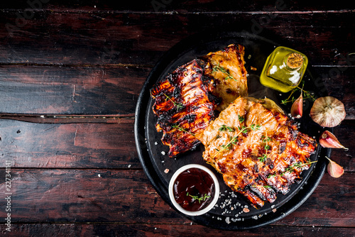 Grilled meat concept. bbq pork ribs with barbeque sauce, olive oil. fresh herbs copy space photo