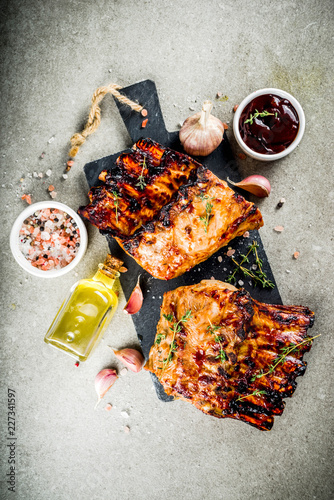 Grilled meat concept. bbq pork ribs with barbeque sauce, olive oil. fresh herbs copy space