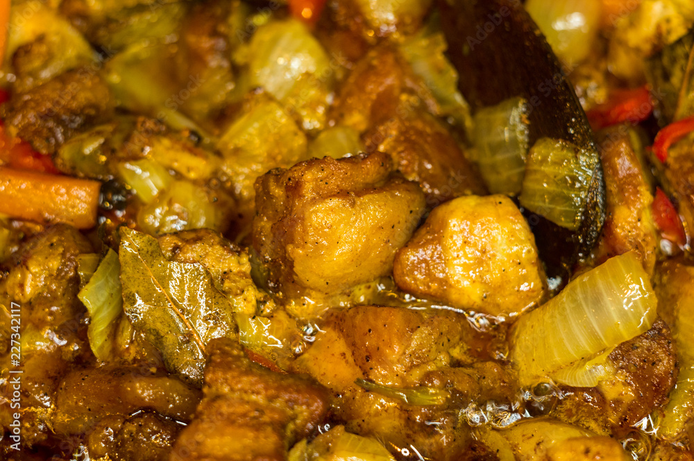 Roast meat, onions, carrots and spices, boiling in oil Roast meat, onions, carrots and spices, boiling in oil
