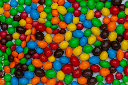 Sweet bonbon colorful candy of different size and color, texture or background. top view, horizontal photo