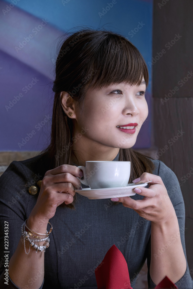 Chinese woman holding a cup Chinese woman holding a cup