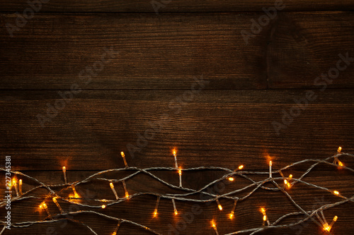 Christmas garland lights on brown wooden table