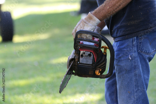 Senior Man Using Chainsaw